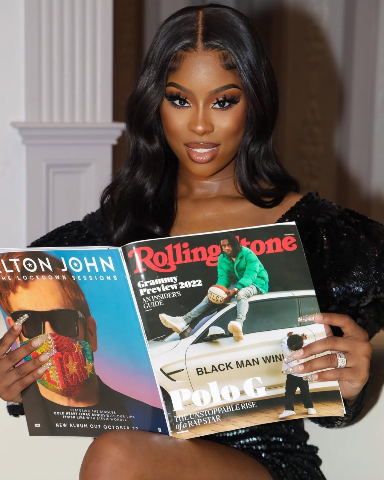 Woman holding fashion and music magazines